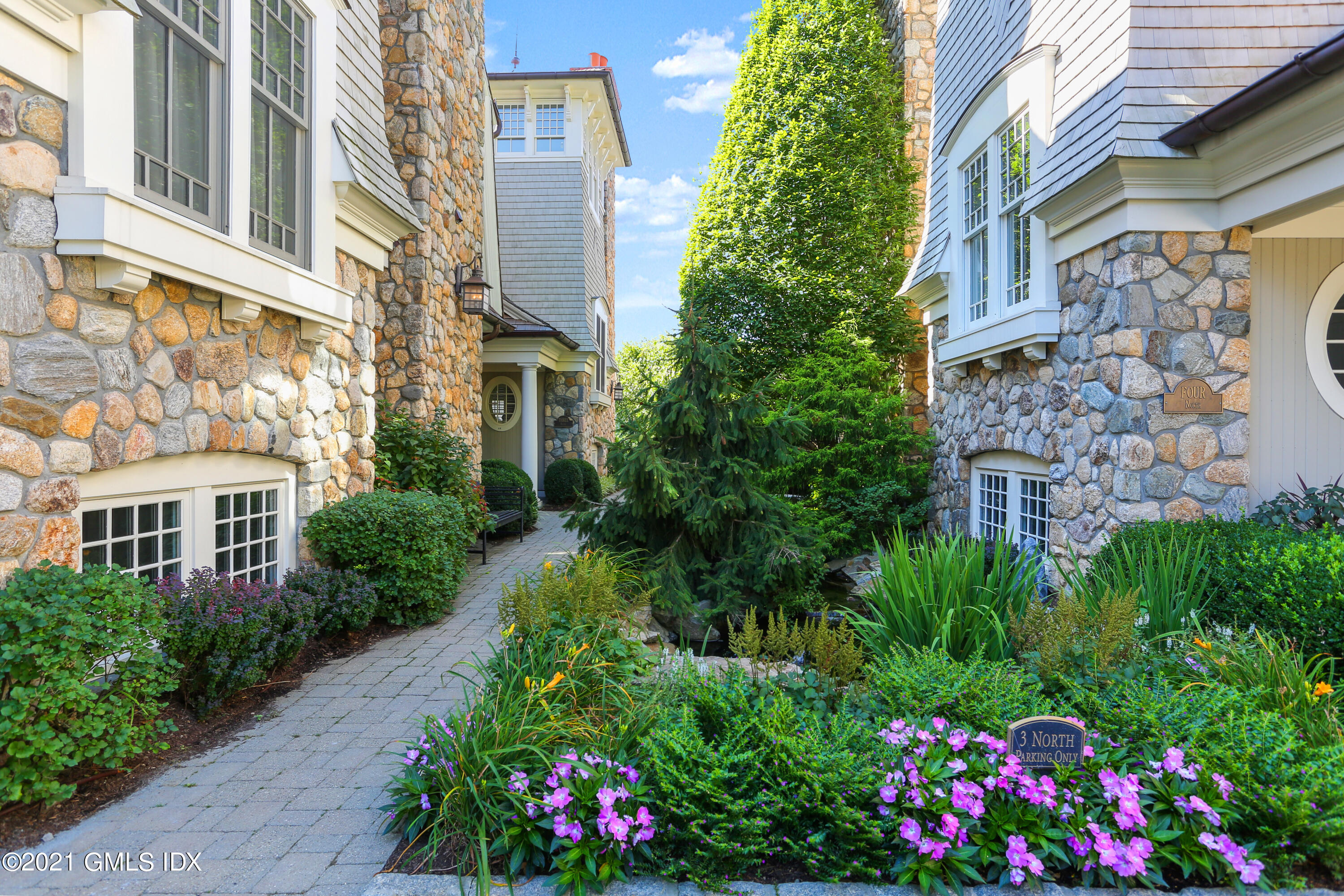 50 Sound View Drive, Unit 2 SOUTH Greenwich, CT 06830 - Photo 17 of 21 a view of a multi story building center a yard and plants
