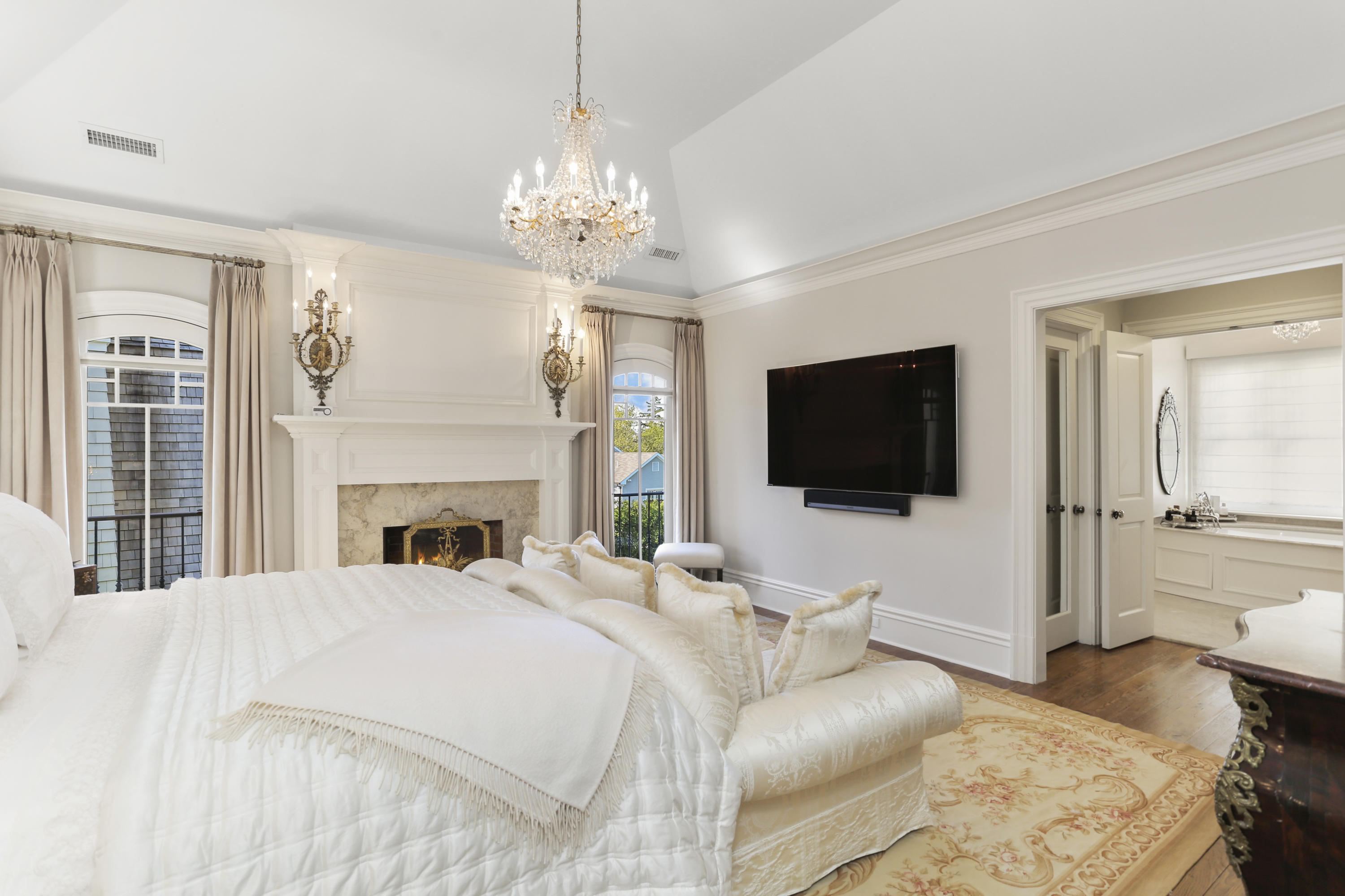 50 Sound View Drive, Unit 2 SOUTH Greenwich, CT 06830 - Photo 9 of 21 a bedroom with a bed and a flat screen tv