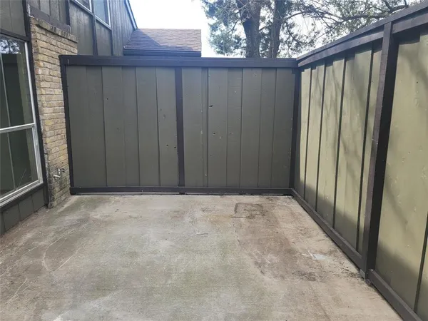 a view of an empty room with wooden fence