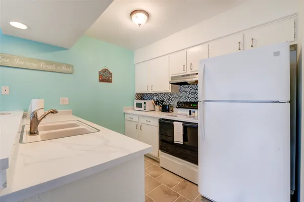 a kitchen with stainless steel appliances a refrigerator sink and cabinets