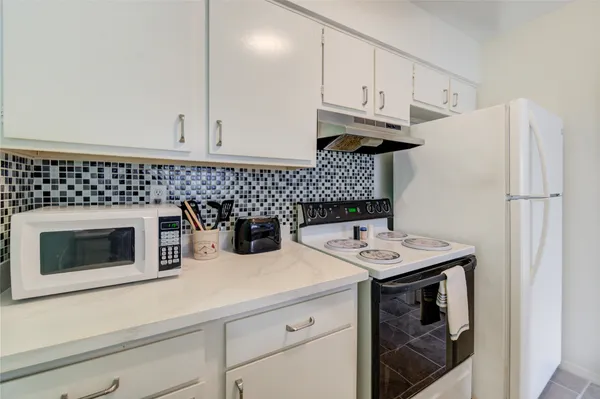 a kitchen with stainless steel appliances granite countertop a sink stove and microwave