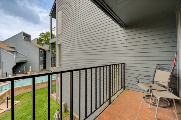 a view of a balcony with furniture