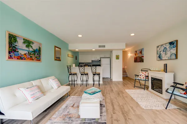 a living room with furniture and kitchen view