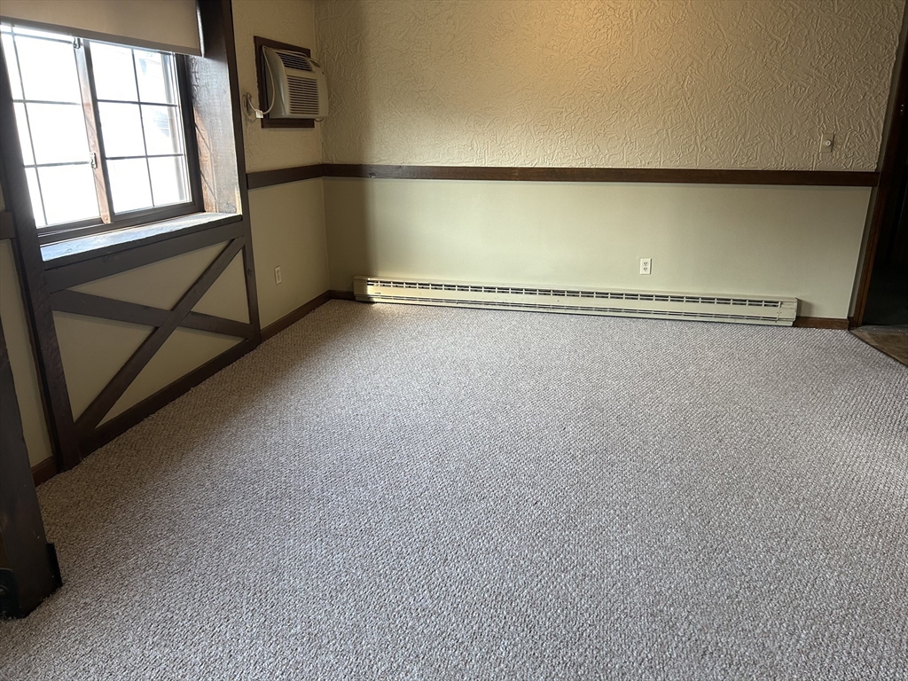 75 Winthrop Street, Unit 334 Everett, MA 02149 - Photo 2 of 8 a view of a room with rack on the wall and a window