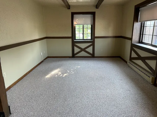 a view of an empty room with windows