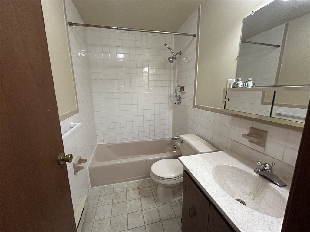 75 Winthrop Street, Unit 334 Everett, MA 02149 - Photo 7 of 8 a bathroom with a sink a toilet and shower