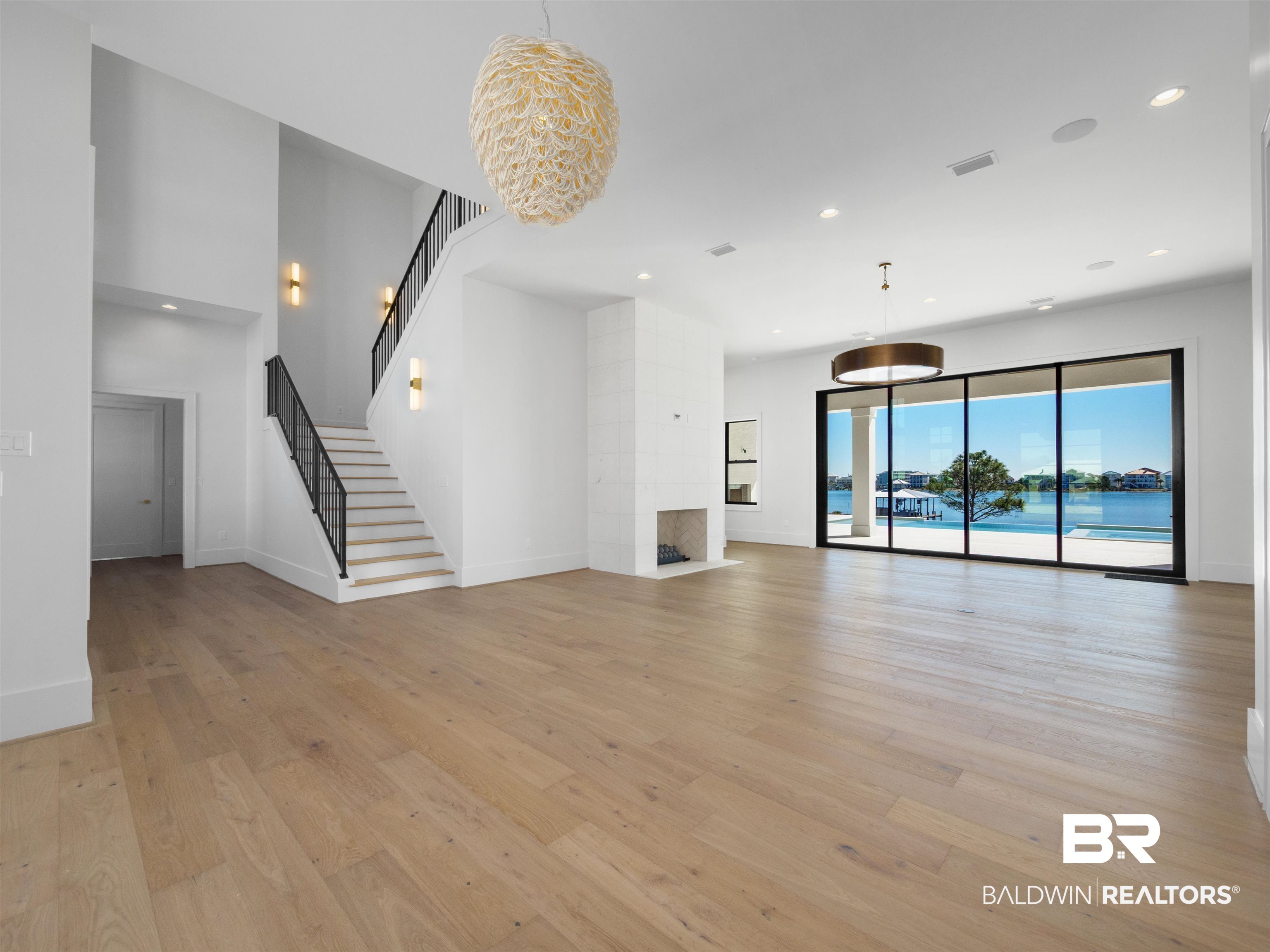 31292 River Road Orange Beach, AL 36561 - Photo 12 of 48 Unfurnished living room featuring recessed lighting, visible vents, light wood finished floors, and stairs