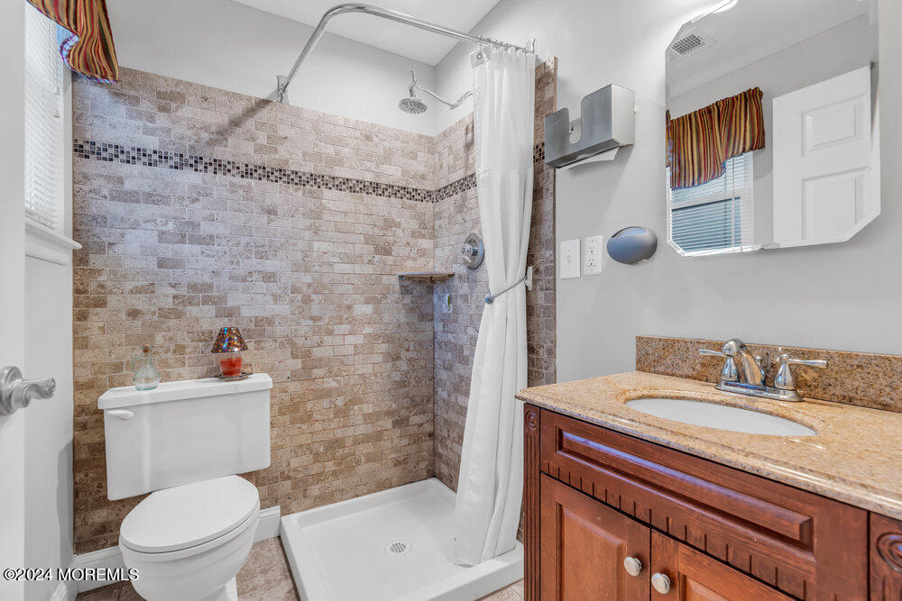 56 Bethany Road Holmdel, NJ 07733 - Photo 12 of 19 a bathroom with a sink toilet and shower