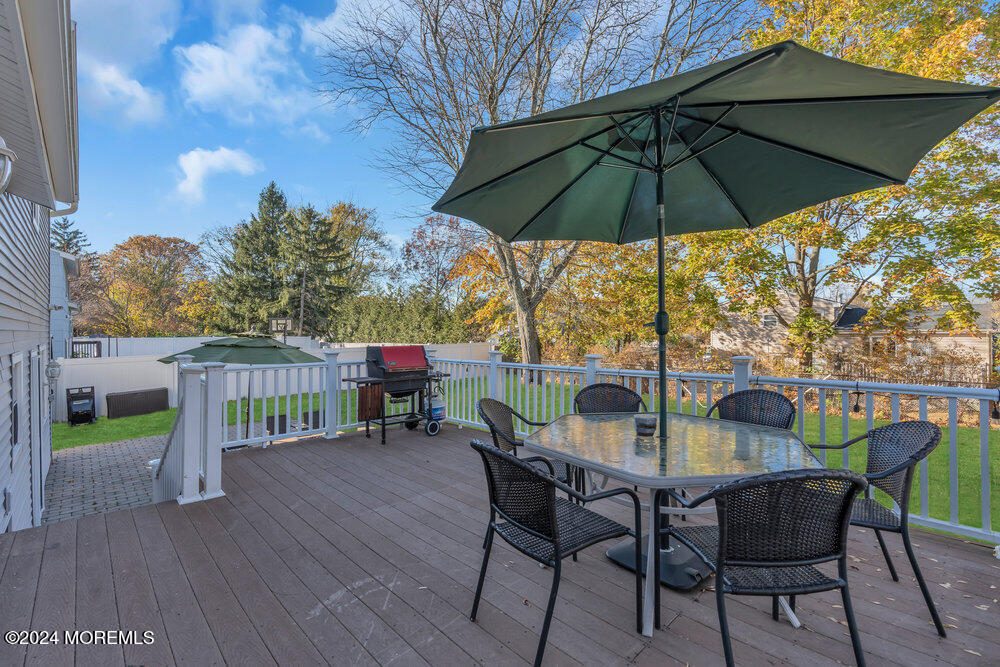 56 Bethany Road Holmdel, NJ 07733 - Photo 15 of 19 a view of deck with furniture and umbrella