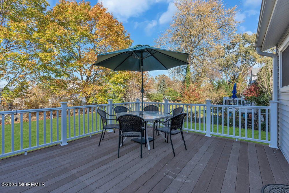 56 Bethany Road Holmdel, NJ 07733 - Photo 16 of 19 a view of balcony with furniture and wooden floor