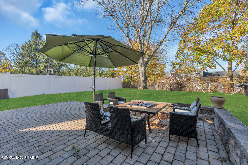56 Bethany Road Holmdel, NJ 07733 - Photo 17 of 19 a backyard of a house with table and chairs