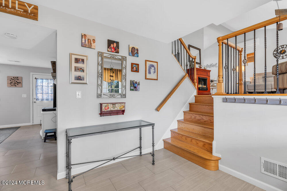 56 Bethany Road Holmdel, NJ 07733 - Photo 2 of 19 a room with stairs and a painting on the wall