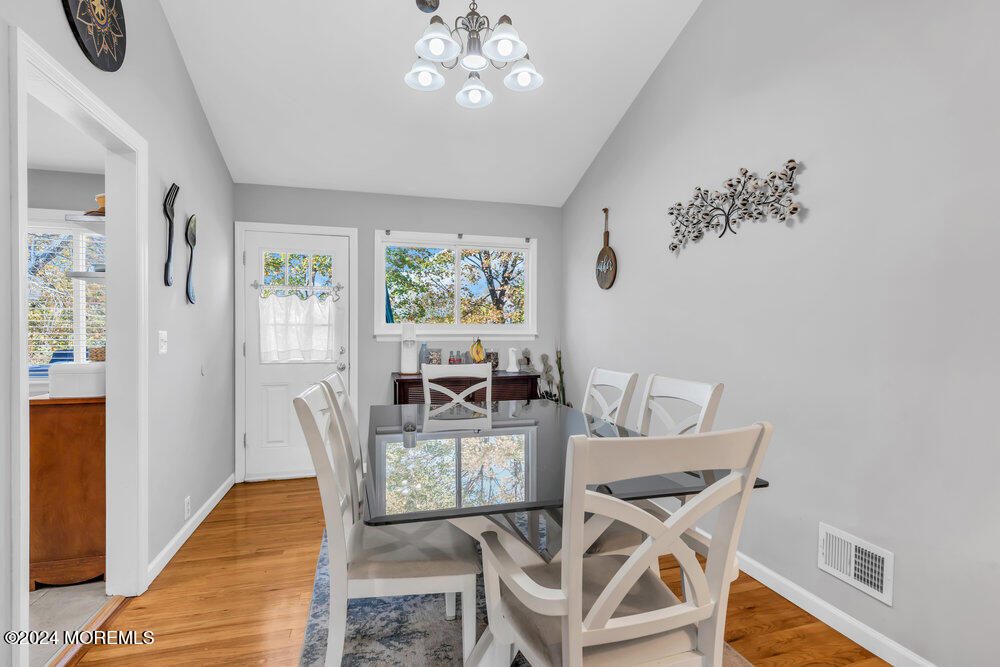 56 Bethany Road Holmdel, NJ 07733 - Photo 4 of 19 a view of a dining room with furniture and wooden floor