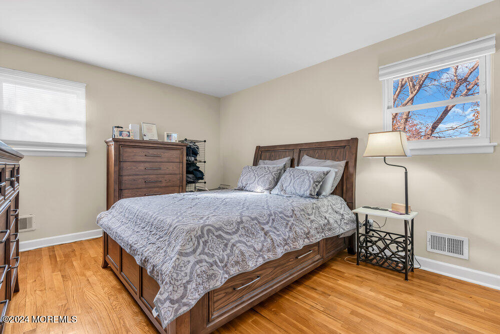 56 Bethany Road Holmdel, NJ 07733 - Photo 8 of 19 a bedroom with a bed and wooden floor