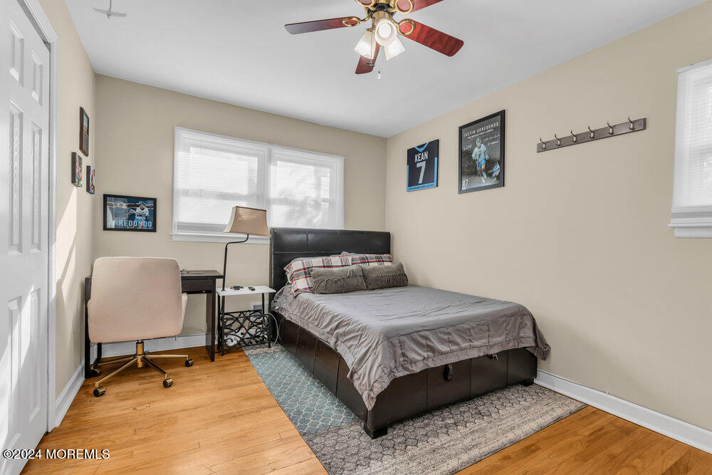 56 Bethany Road Holmdel, NJ 07733 - Photo 10 of 19 a bedroom with a bed a chair and a large window