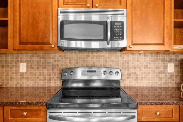 a stove top oven sitting inside of a kitchen