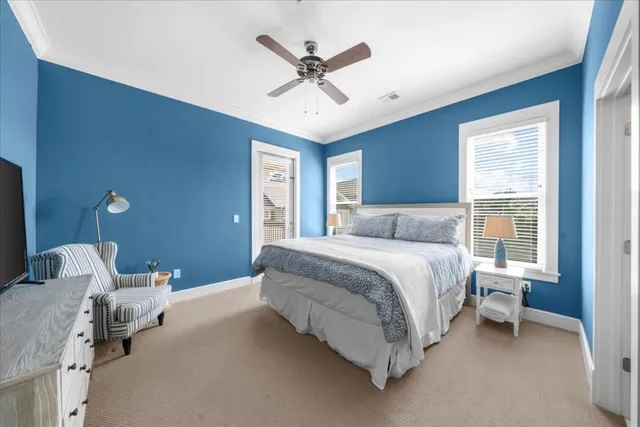 a spacious bedroom with a bed and a chandelier