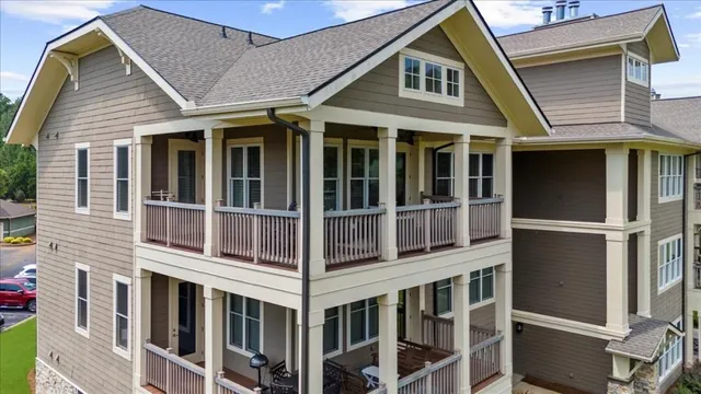 an aerial view of a house with swimming pool patio and outdoor seating