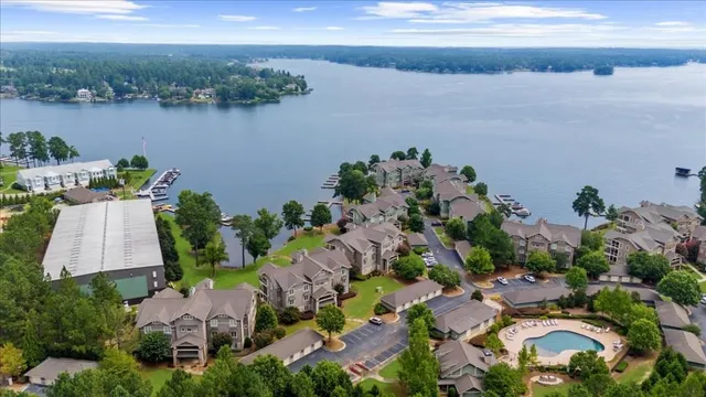 an aerial view of a house with a garden and lake view