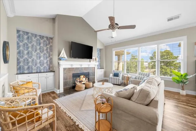 a living room with furniture a fireplace and a flat screen tv