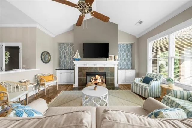 a living room with furniture fireplace and a flat screen tv