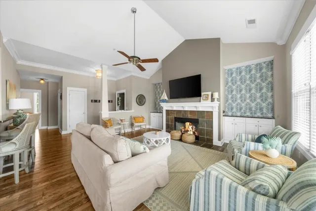 a living room with furniture a fireplace and a flat screen tv