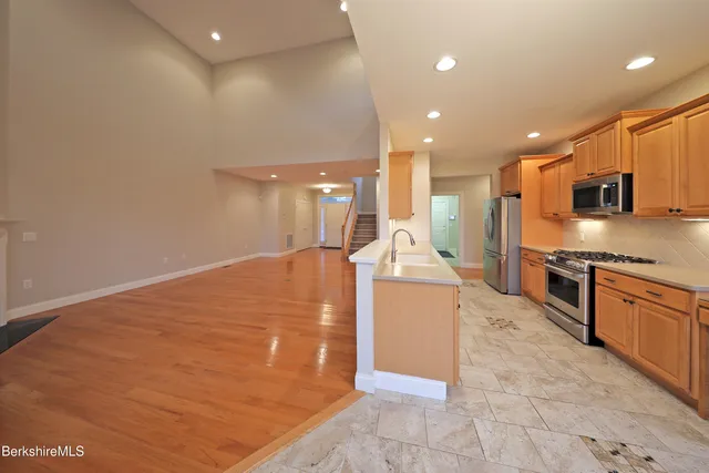 a white toilet sitting next to a bathroom sink and a mirror