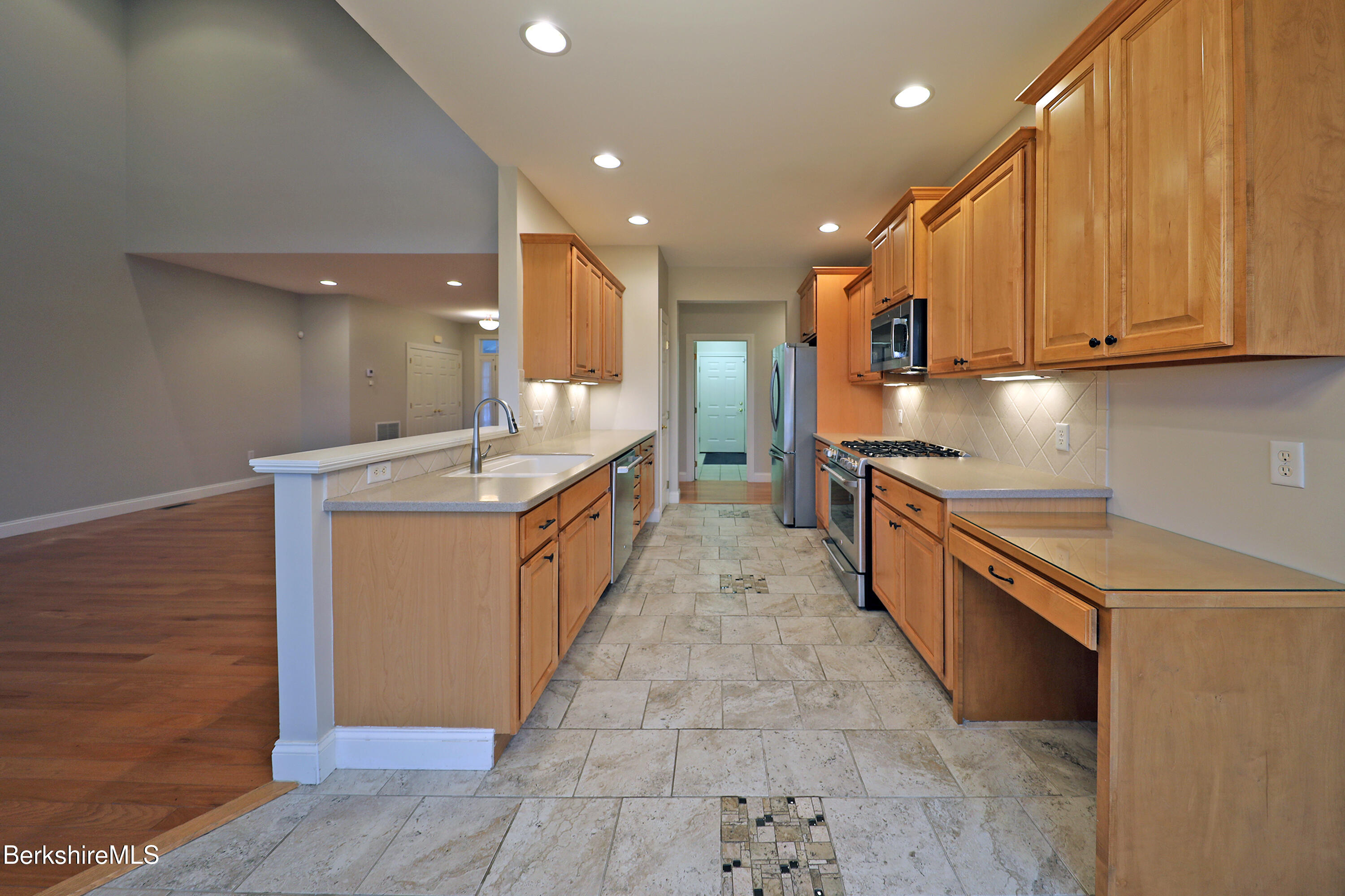 33 Alpine Trail Pittsfield, MA 01201 - Photo 12 of 69 a kitchen with stainless steel appliances granite countertop a sink counter space cabinets and a large window