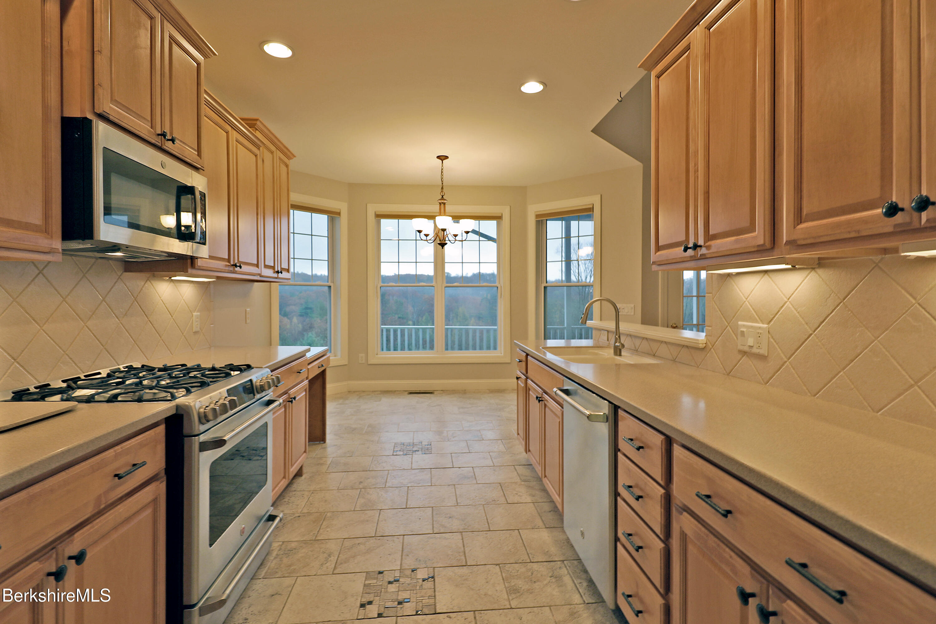 33 Alpine Trail Pittsfield, MA 01201 - Photo 17 of 69 a kitchen with stainless steel appliances granite countertop a stove a sink and a microwave