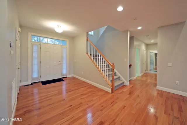 an empty room with windows and entrance to other room