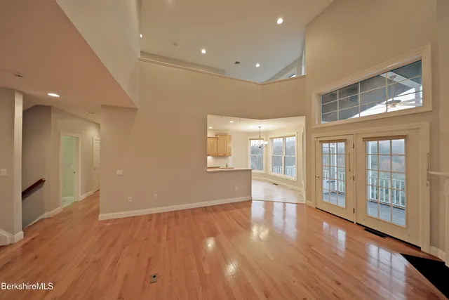 a large kitchen with stainless steel appliances a large counter top and a stove
