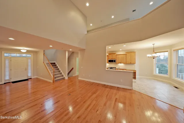 a kitchen with stainless steel appliances granite countertop a sink counter space cabinets and a large window