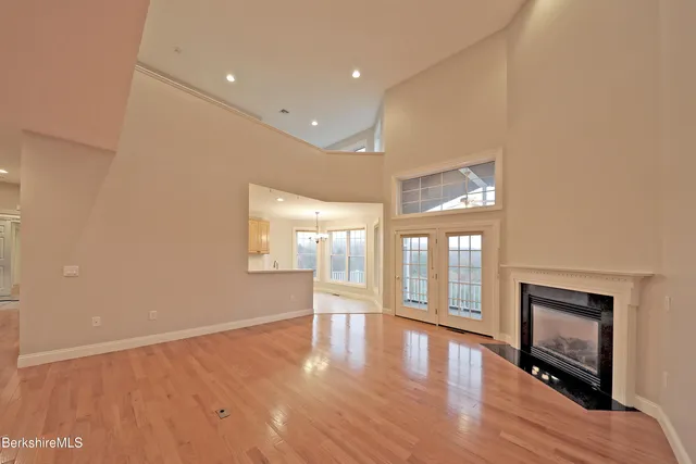 a bathroom with a glass door shower a sink and a large mirror