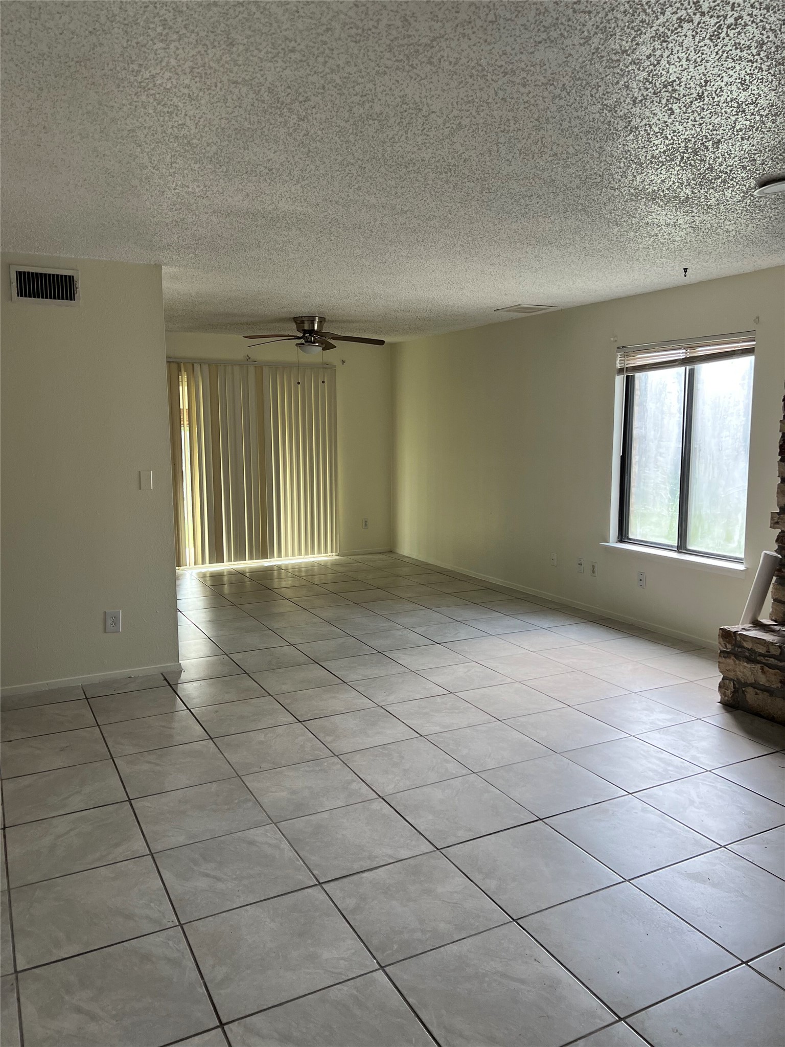8423 Fathom Circle, Unit B Austin, TX 78750 - Photo 2 of 5 an empty room with windows and fireplace
