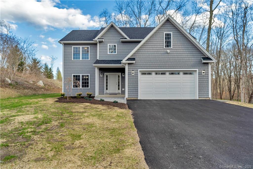 6 Lindera Lane Clinton, CT 06413 - Photo 1 of 1 a front view of a house with a yard and garage