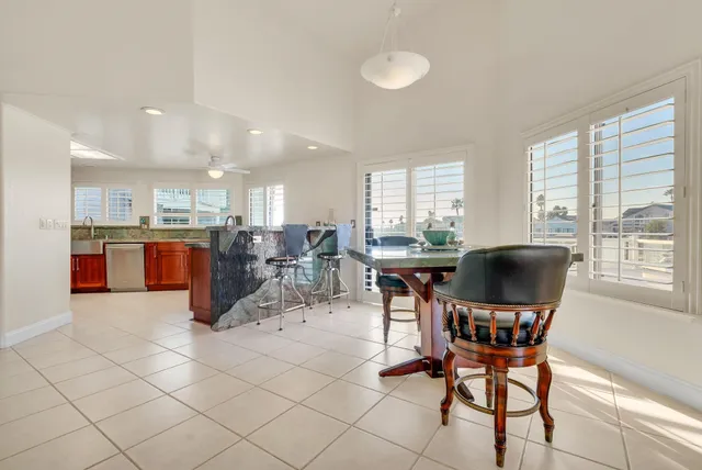 a view of kitchen with granite countertop cabinets table and chairs