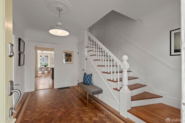 a view of entryway and hall with wooden floor