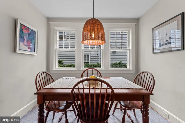 a view of a dining room with furniture wooden floor and windows