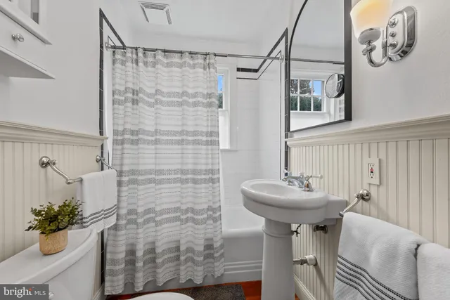 a bathroom with a sink a mirror and a shower