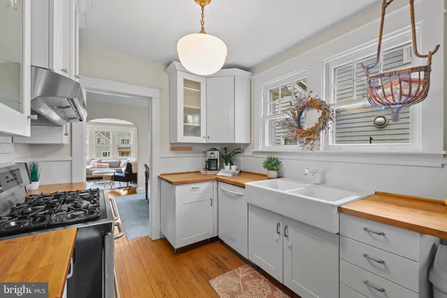 a kitchen with a sink stove and cabinets