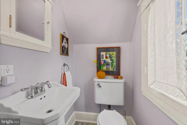 a bathroom with a sink mirror and toilet