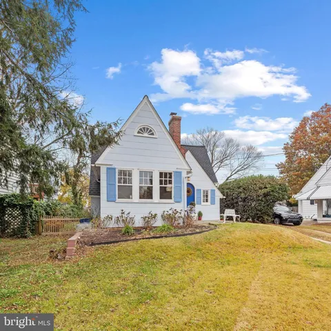 a front view of house with yard and trees around