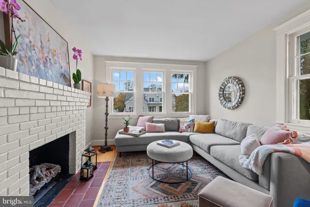 a living room with furniture a fireplace and window