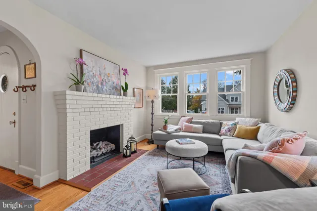 a living room with furniture a rug and a fireplace