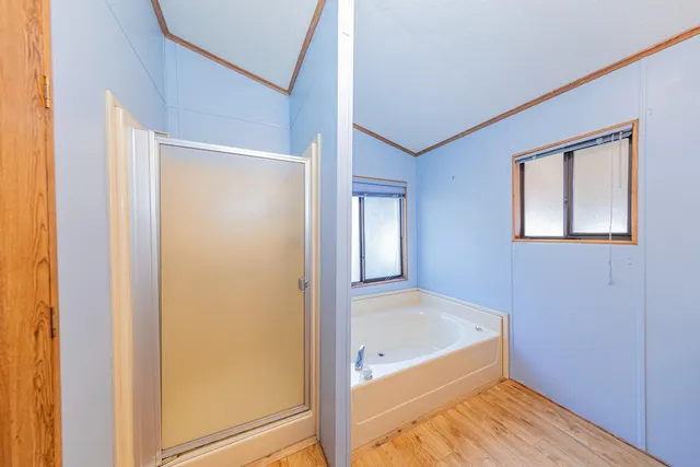 a bathroom with a tub and shower