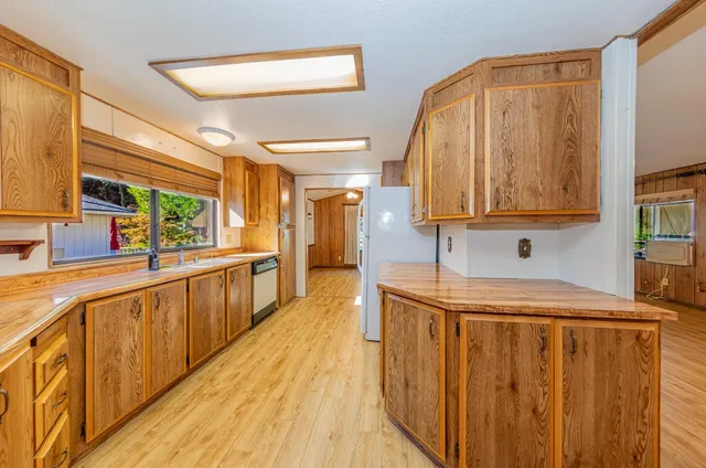 a view of a kitchen with a sink and wooden floor
