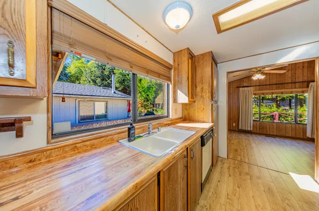 a view of a kitchen with a sink and wooden floor
