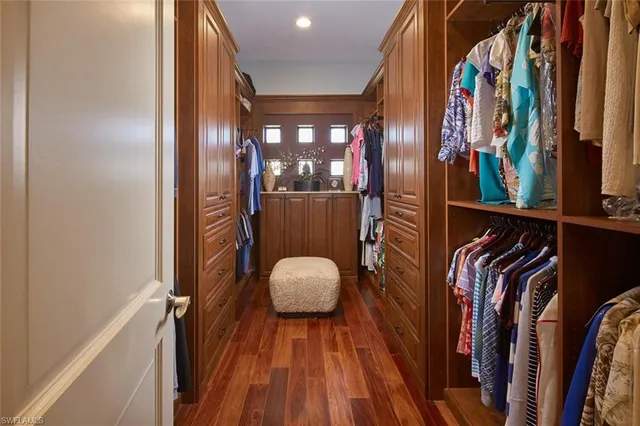 a view of walk in closet with clothes and shoes