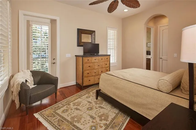 a bathroom with a granite countertop sink mirror vanity and toilet