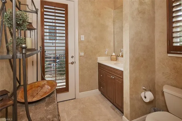 a view of a hallway with wooden shelves